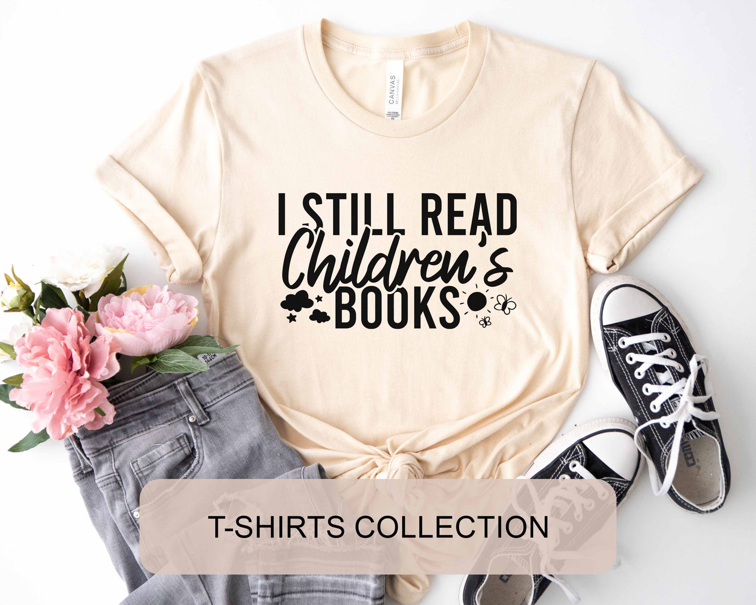 A natural color shirt with the saying "I still read children's books"