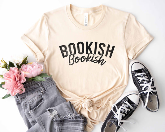 A natural color shirt with the saying "Bookish"
