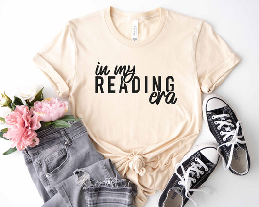 A natural color shirt with the saying "In my reading era"