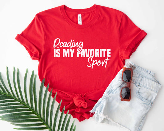 A red color shirt with the saying "Reading is my favorite sport"