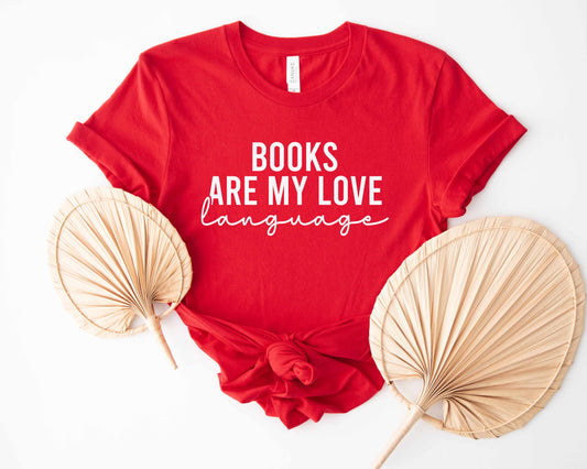 A red color shirt with the saying "Books are my love language"
