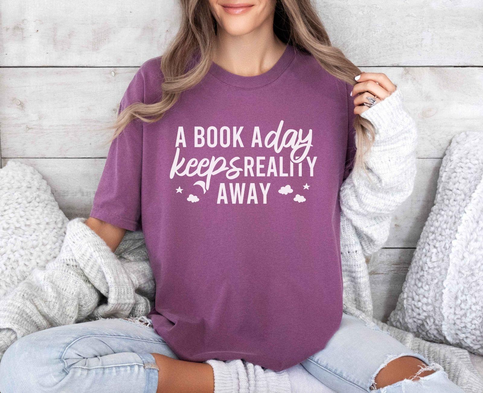 A comfort colors® shirt with the saying "A book a day keeps reality away"