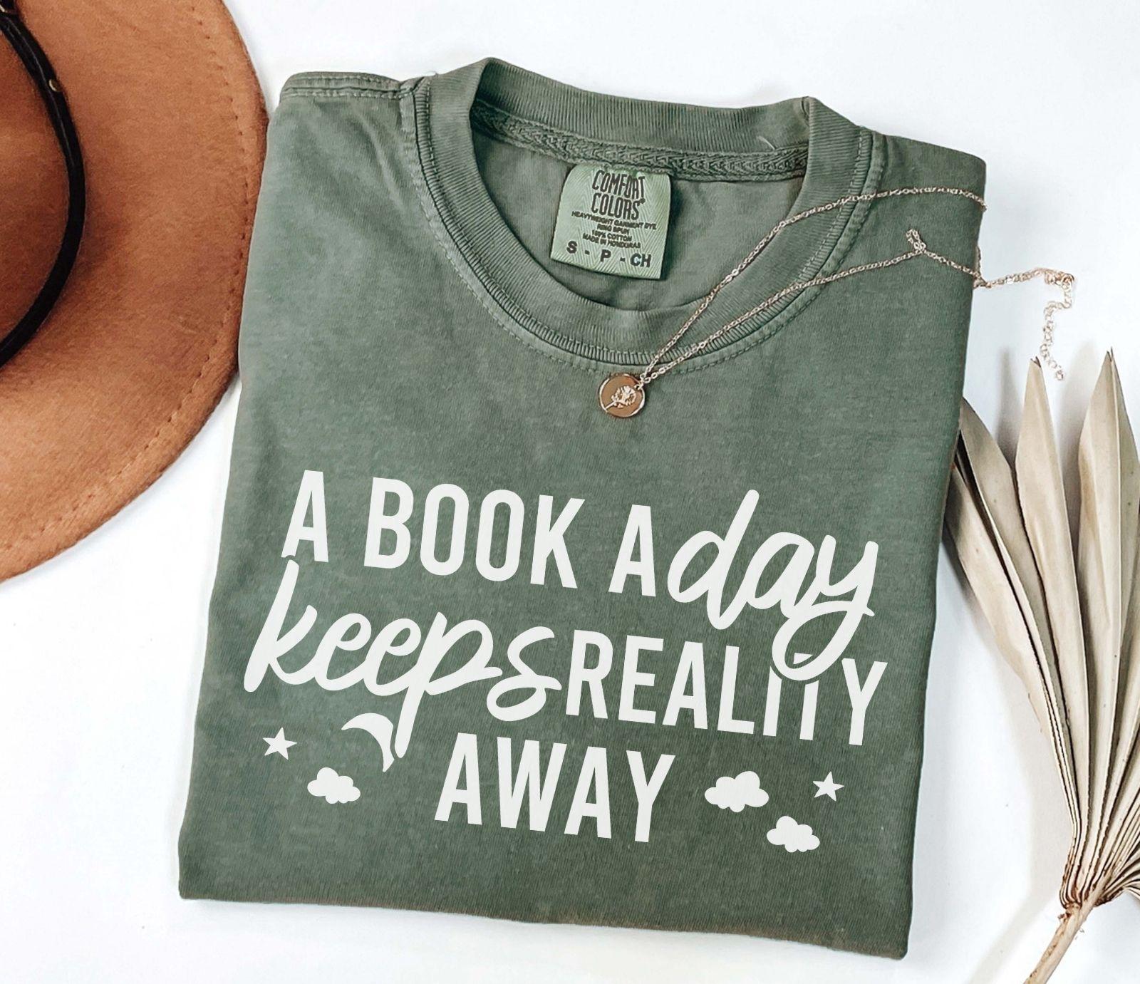 A comfort colors® shirt with the saying "A book a day keeps reality away"