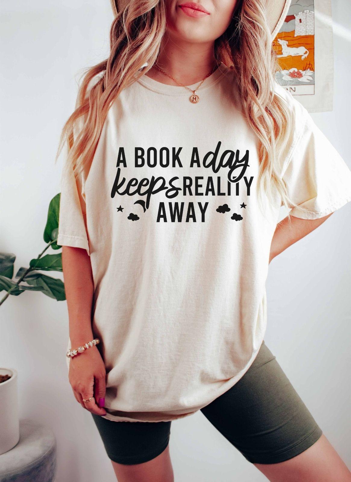 A comfort colors® shirt with the saying "A book a day keeps reality away"