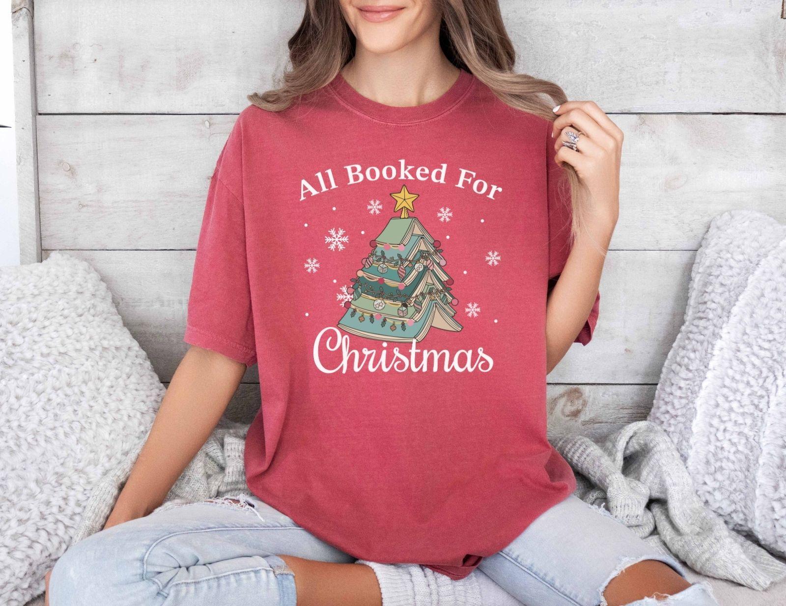 A comfort colors® shirt with the saying "All booked for Christmas"