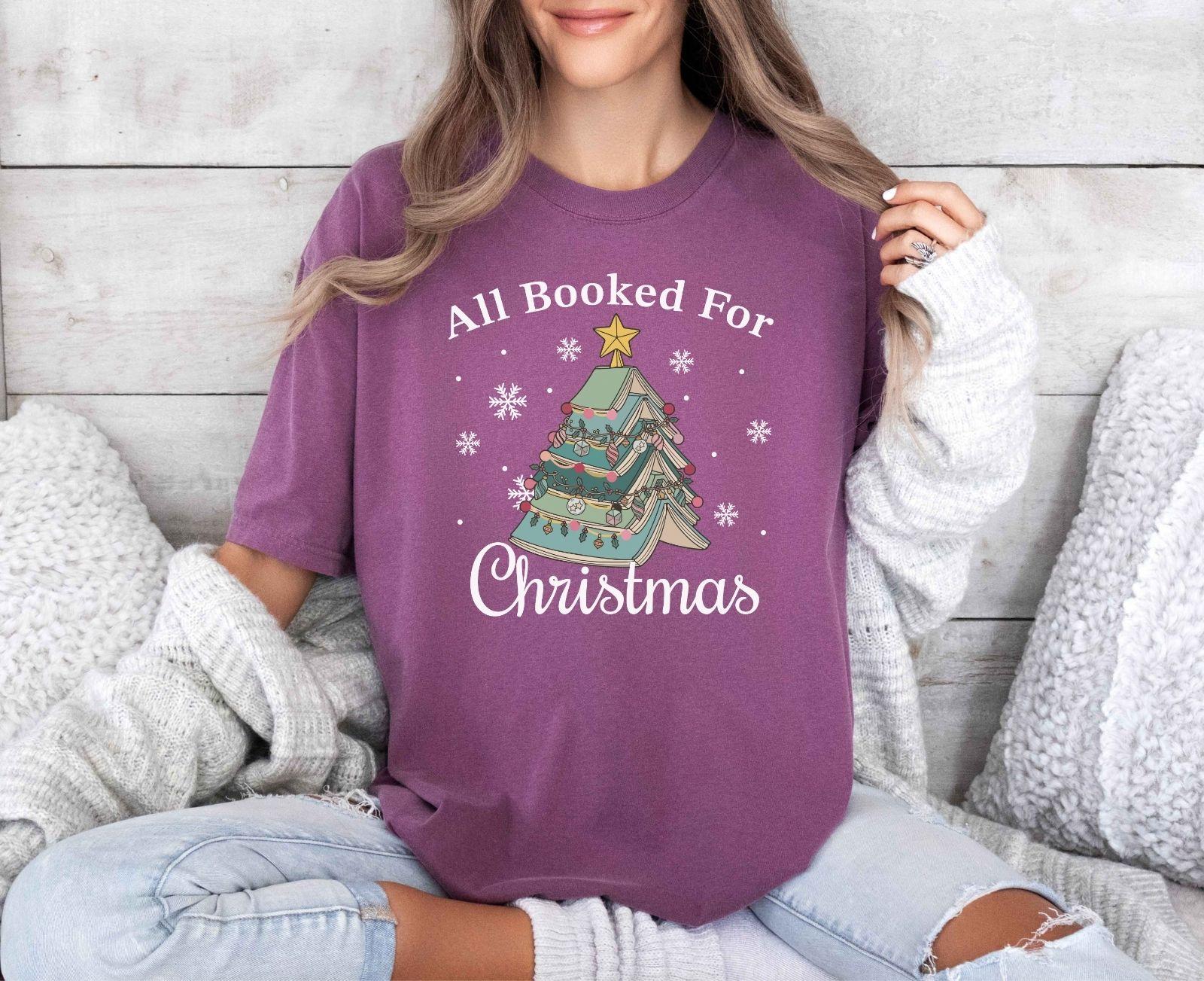 A comfort colors® shirt with the saying "All booked for Christmas"