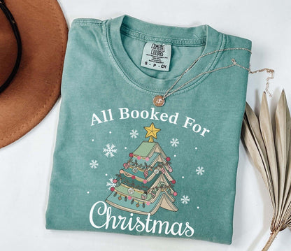 A comfort colors® shirt with the saying "All booked for Christmas"