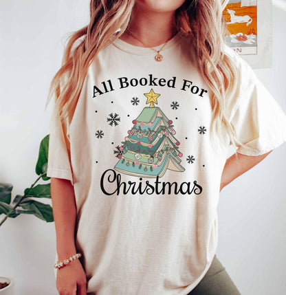 A comfort colors® shirt with the saying "All booked for Christmas"