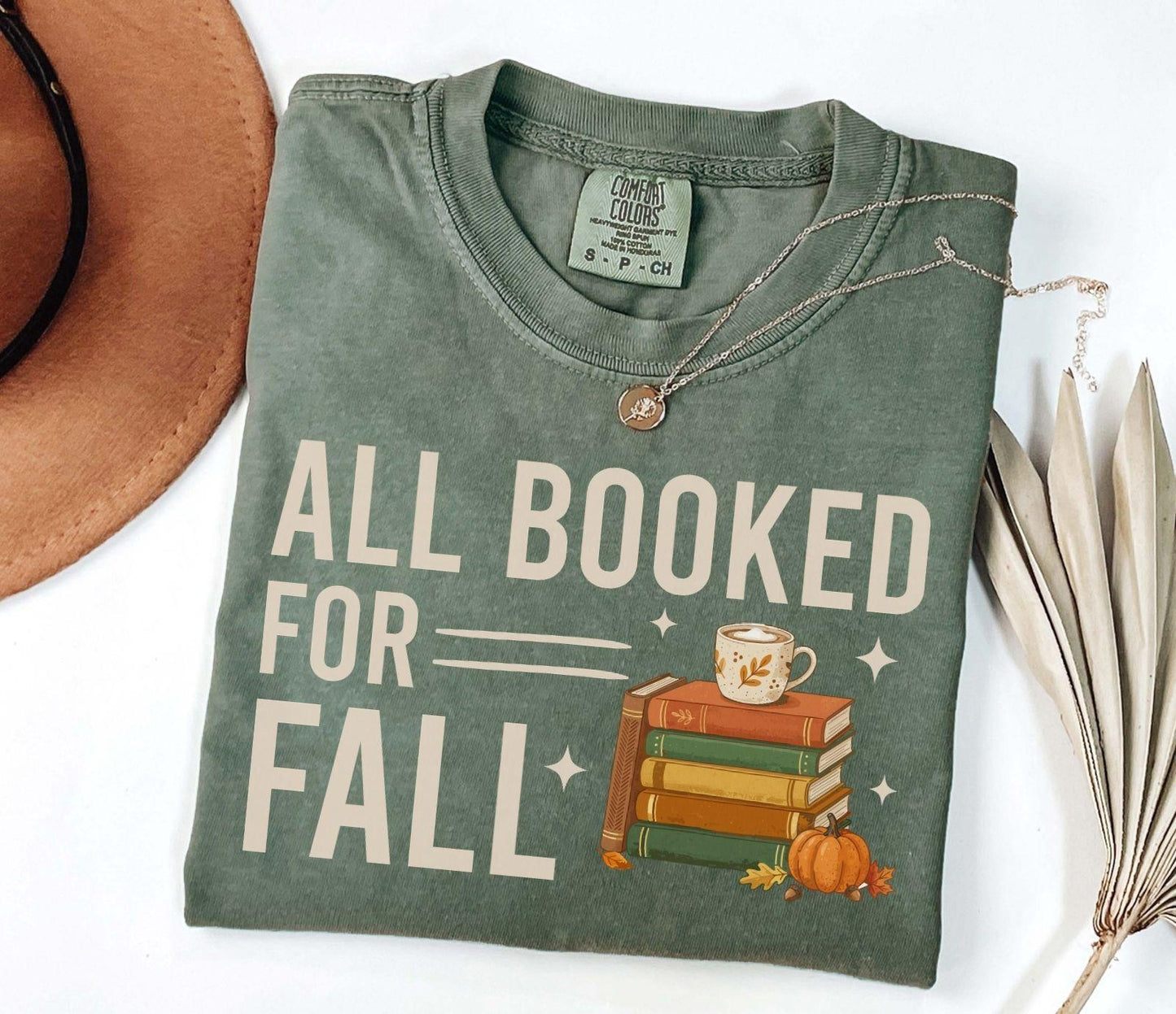 A comfort colors® shirt with the saying "all booked for fall"