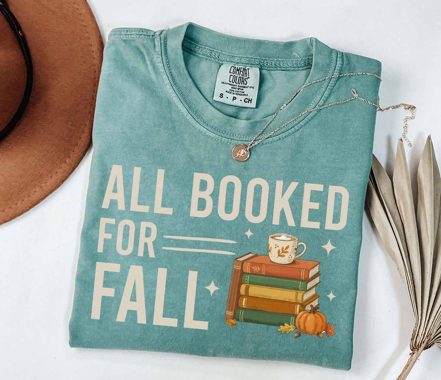 A comfort colors® shirt with the saying "all booked for fall"