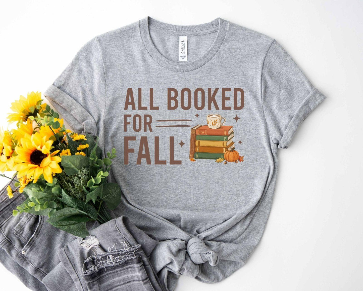 A bella canvas 3001 shirt with the saying "all booked for fall"