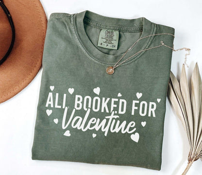 A comfort colors® shirt with the saying "all booked for valentine"