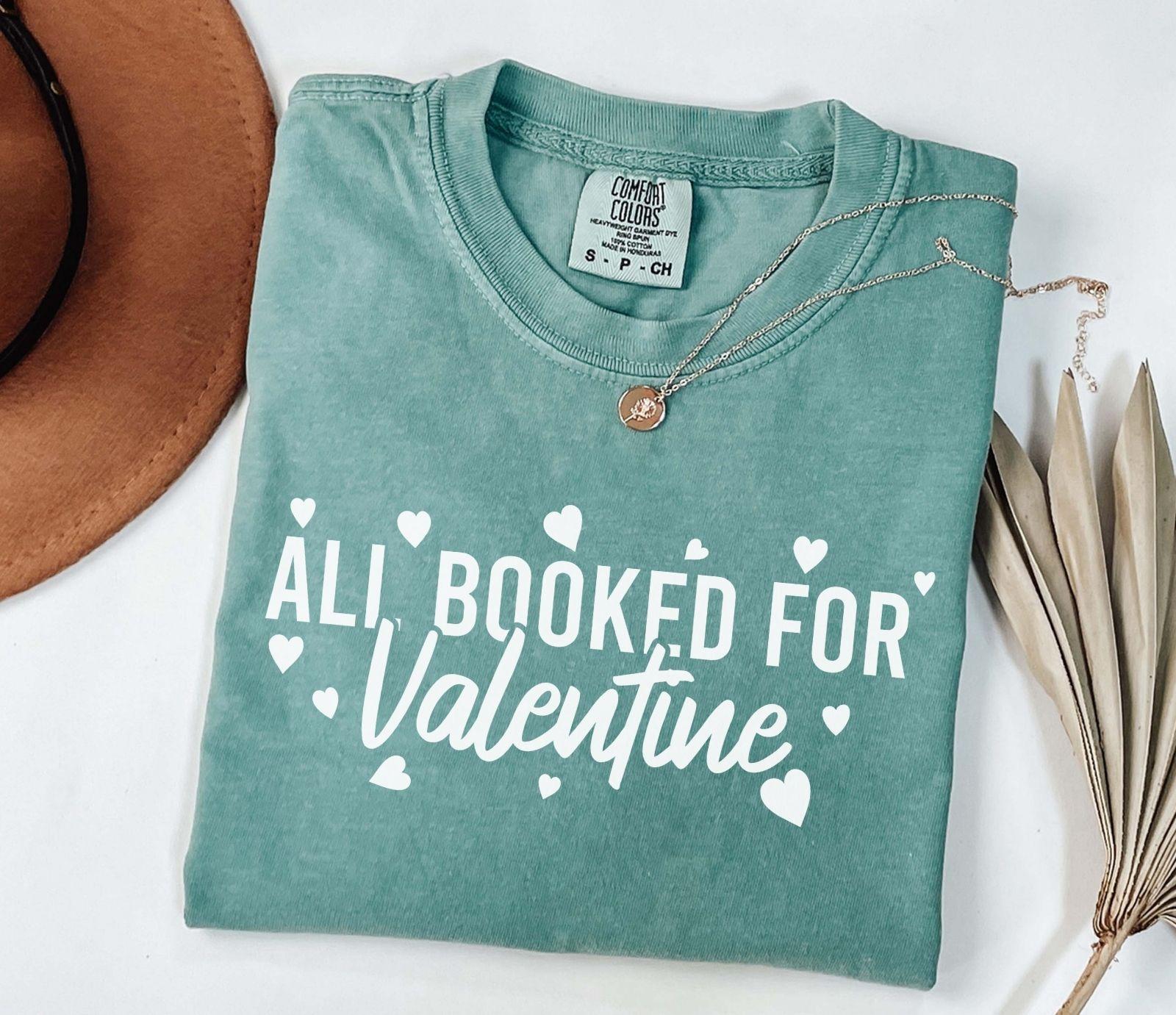 A comfort colors® shirt with the saying "all booked for valentine"