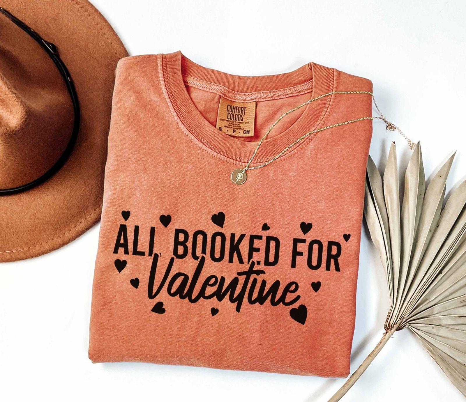 A comfort colors® shirt with the saying "all booked for valentine"