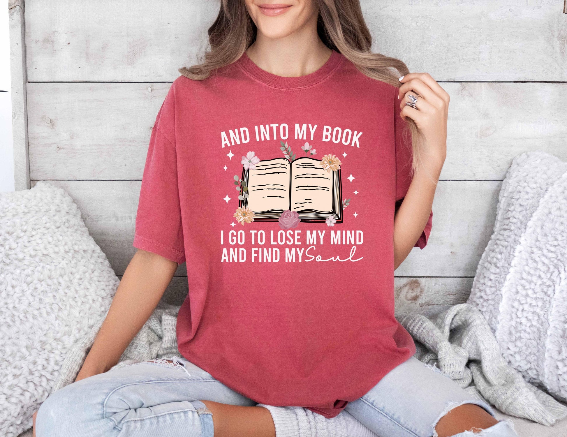 A comfort colors shirt with the saying "And into my book I go to lose my mind and find my soul"
