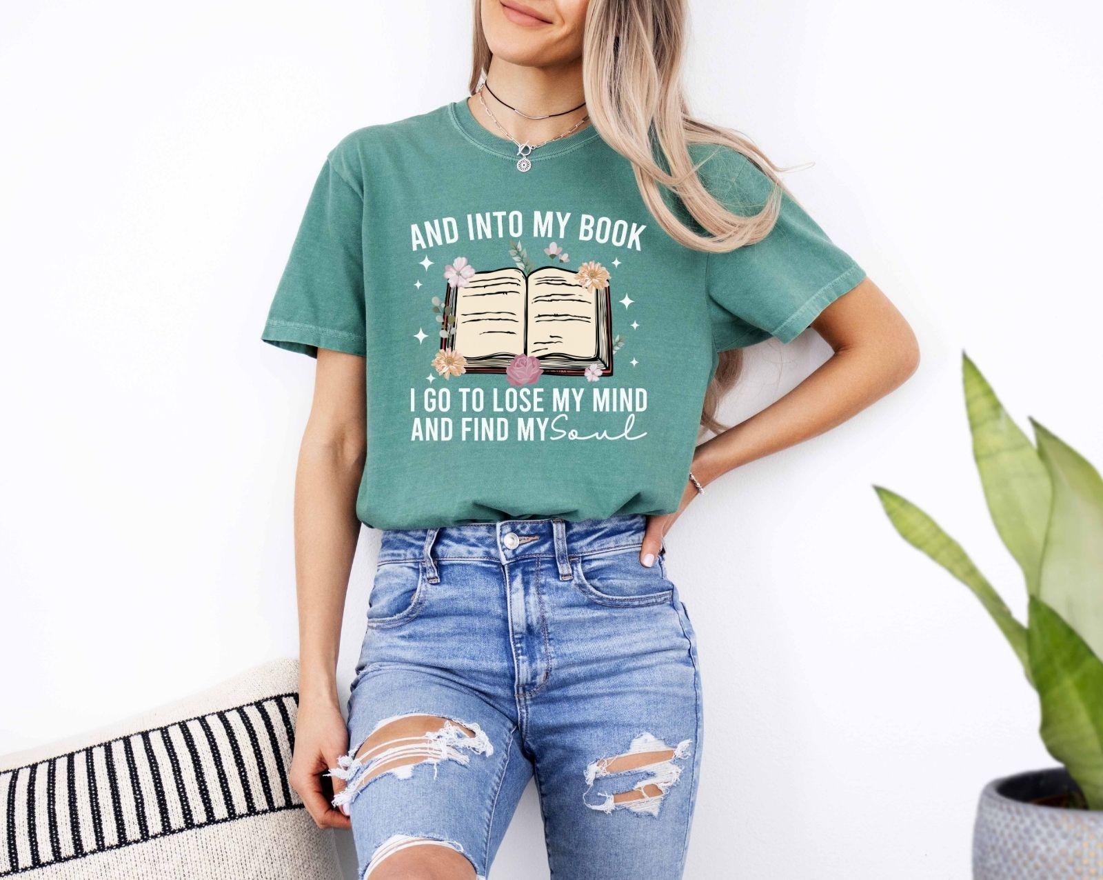 A comfort colors shirt with the saying "And into my book I go to lose my mind and find my soul"