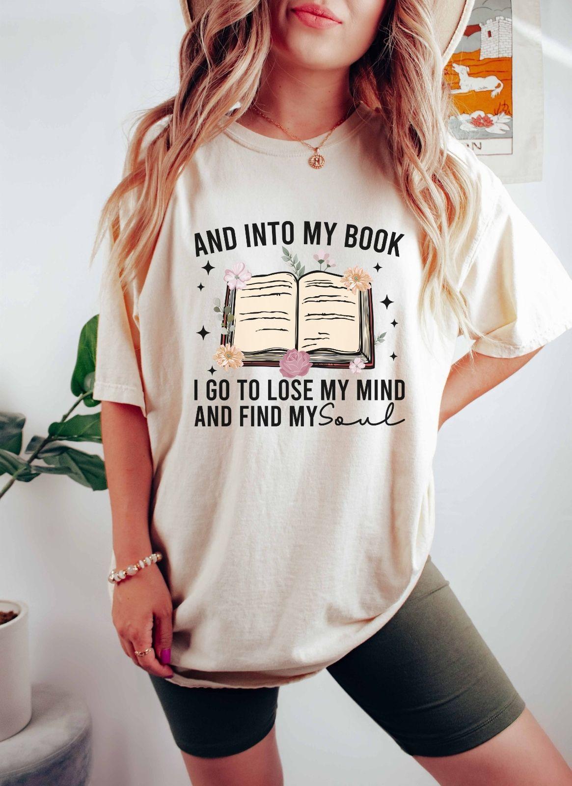 A comfort colors shirt with the saying "And into my book I go to lose my mind and find my soul"