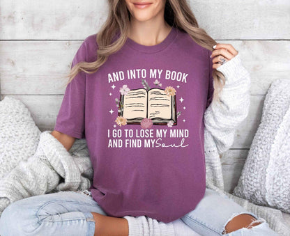A comfort colors shirt with the saying "And into my book I go to lose my mind and find my soul"