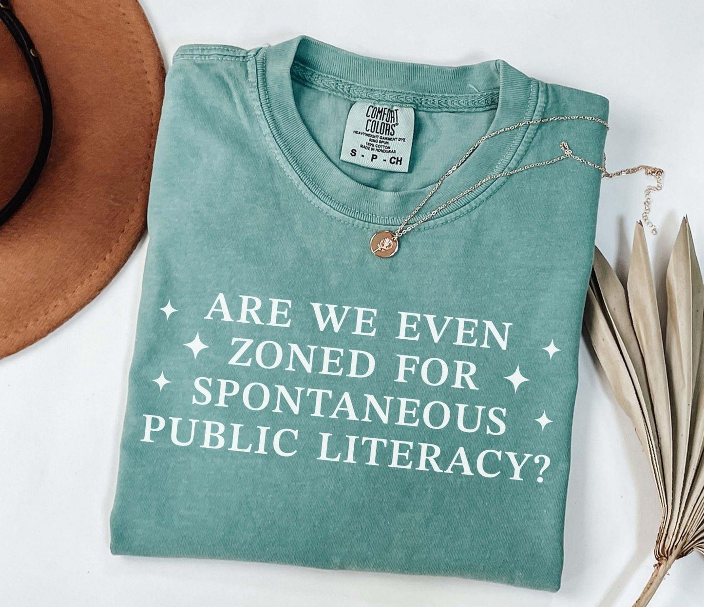 A comfort colors® shirt with the saying "Are We Even Zoned For Spontaneous Public Literacy"