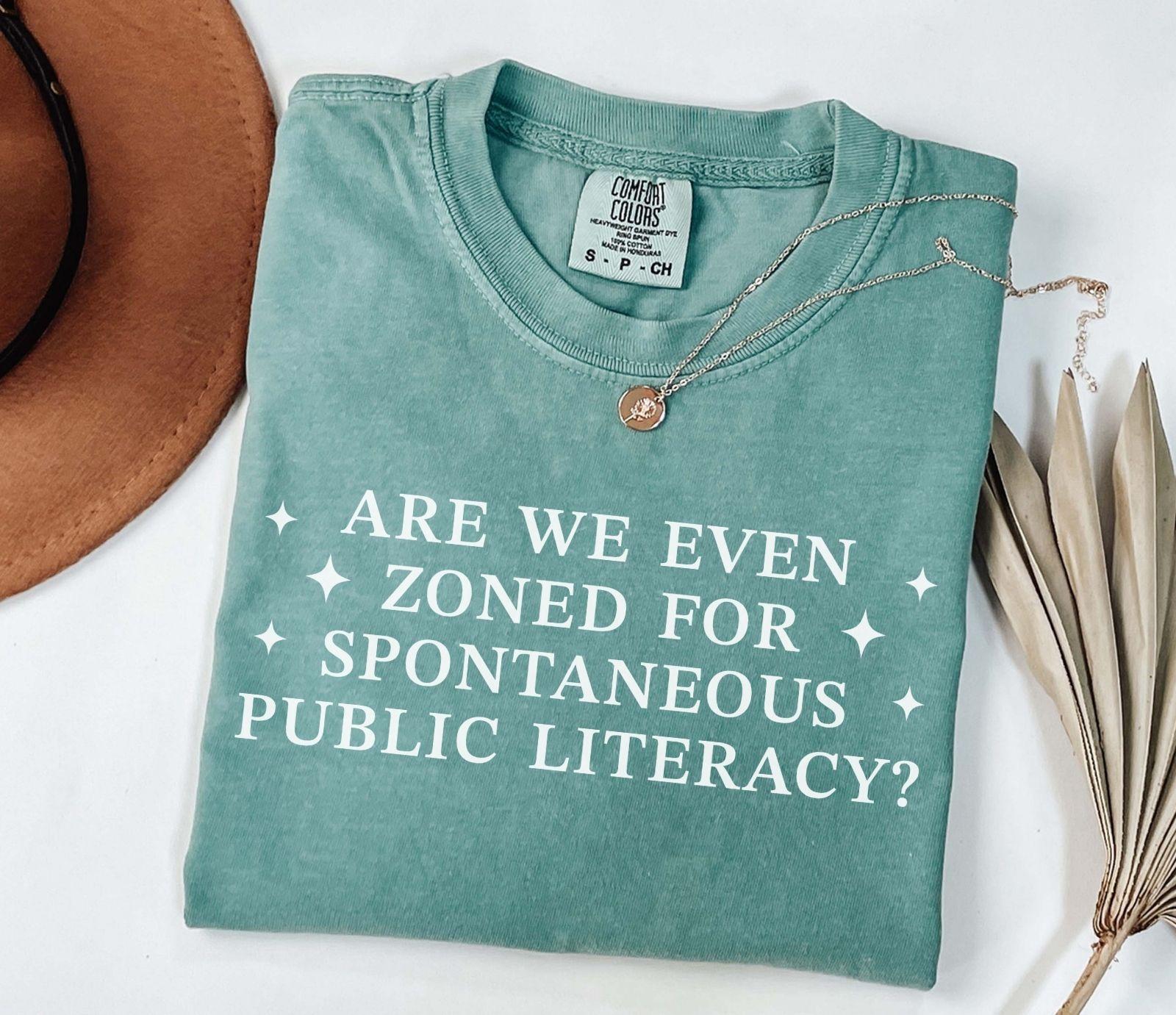 A comfort colors® shirt with the saying "Are We Even Zoned For Spontaneous Public Literacy"
