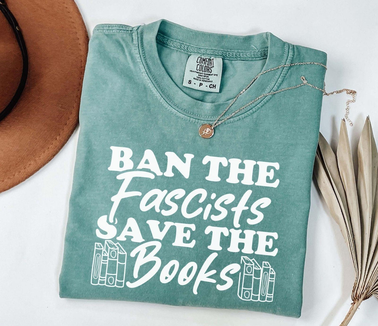 A comfort colors shirt with the saying "Ban the fascists save the books"