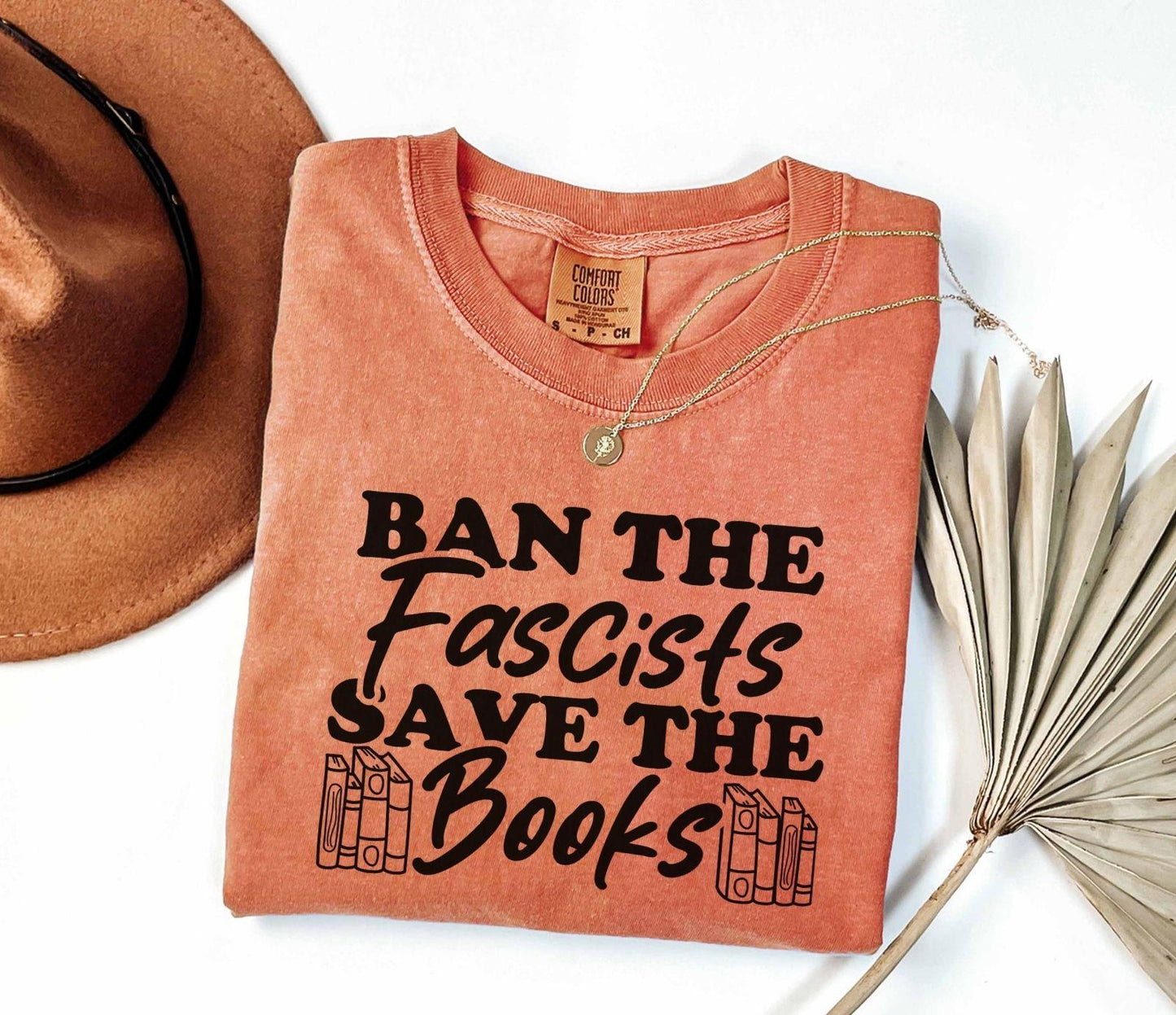 A comfort colors shirt with the saying "Ban the fascists save the books"
