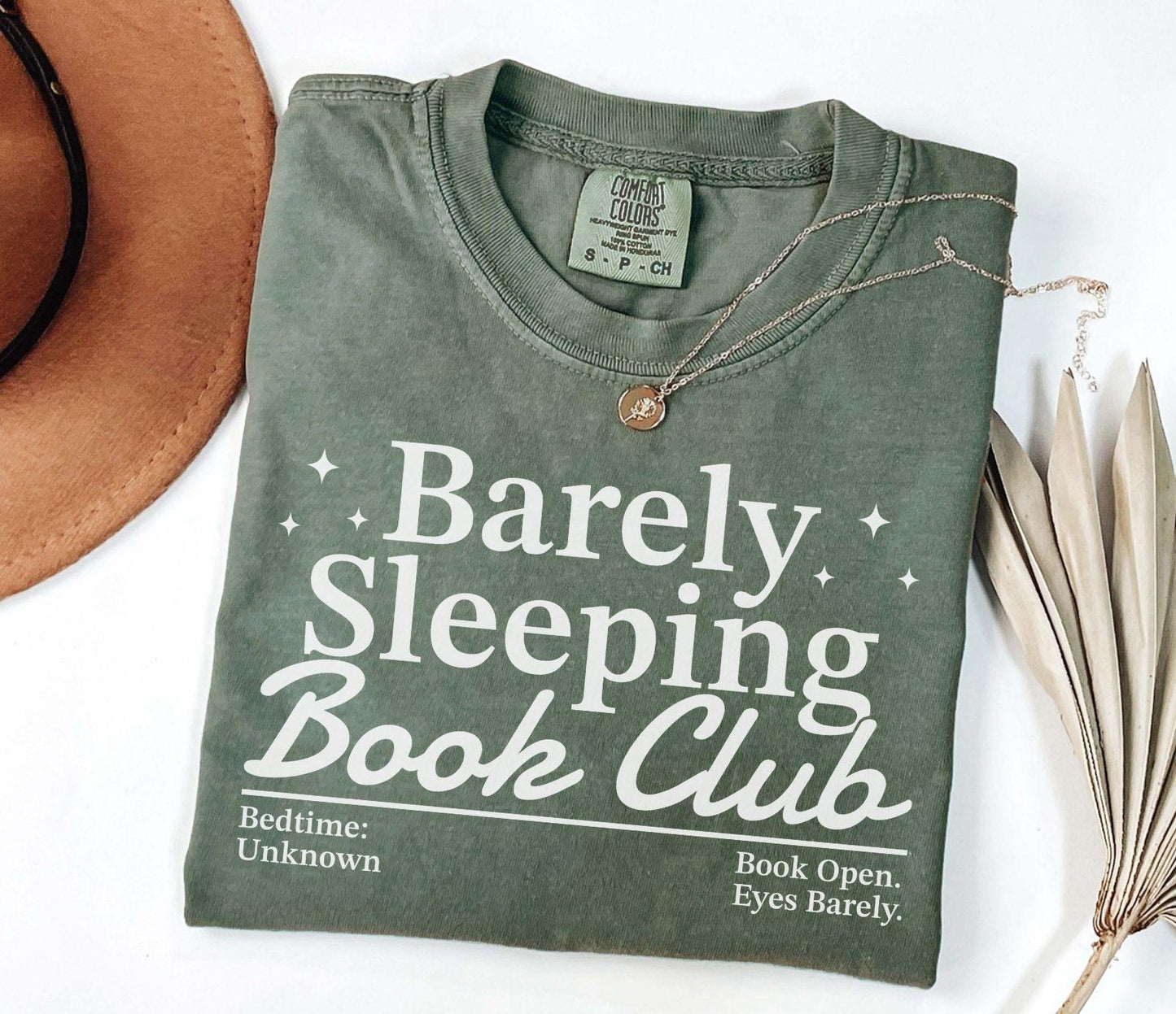 A comfort colors® shirt with the saying "barely sleeping book club"
