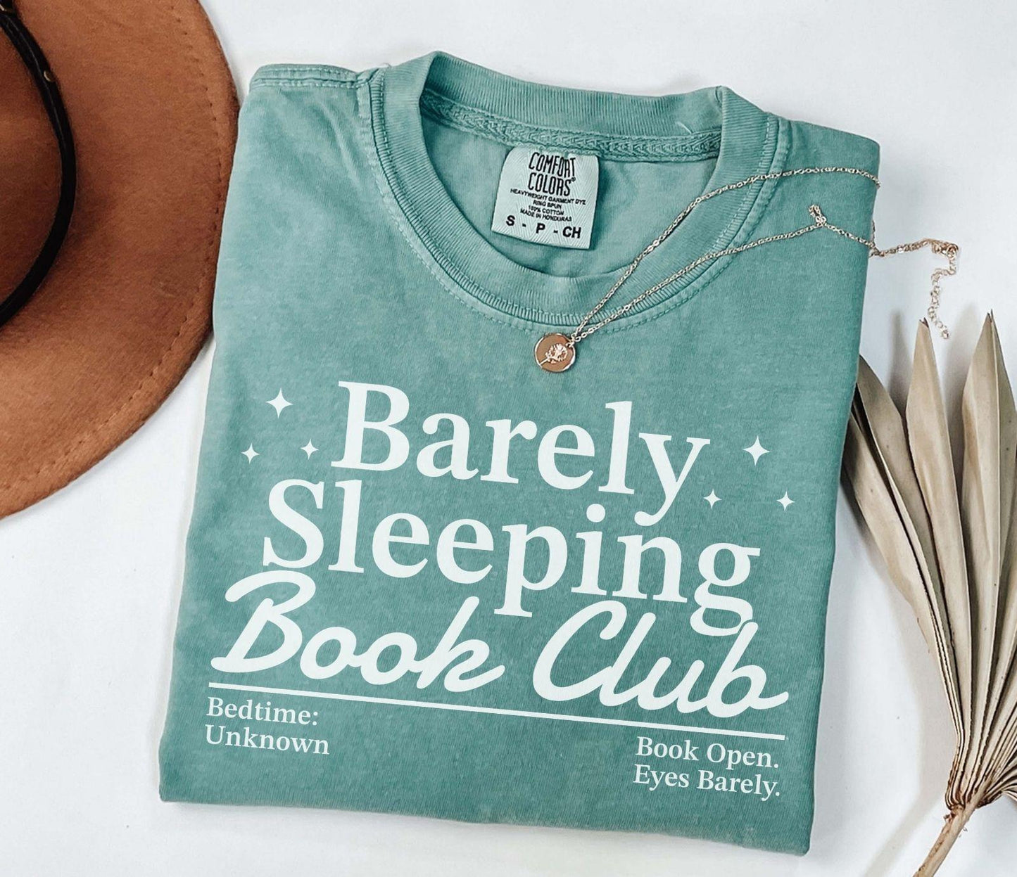 A comfort colors® shirt with the saying "barely sleeping book club"