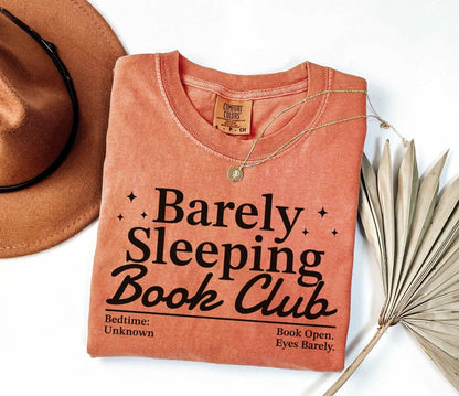 A comfort colors® shirt with the saying "barely sleeping book club"