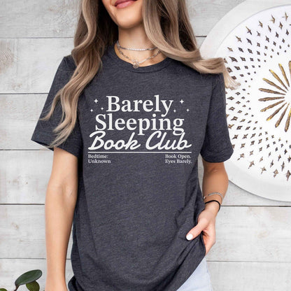 A bella canvas 3001 shirt with the saying "Barely sleeping book club"