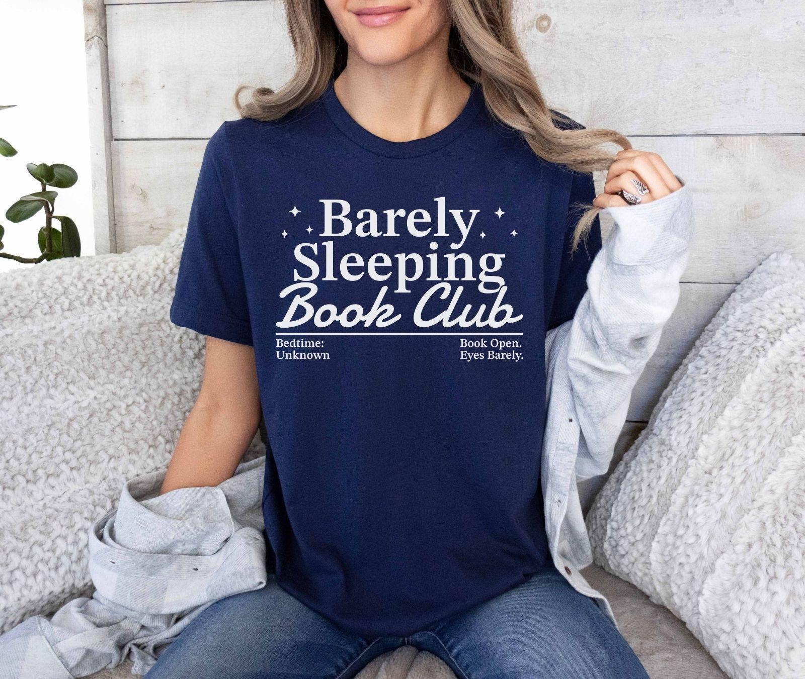 A bella canvas 3001 shirt with the saying "Barely sleeping book club"