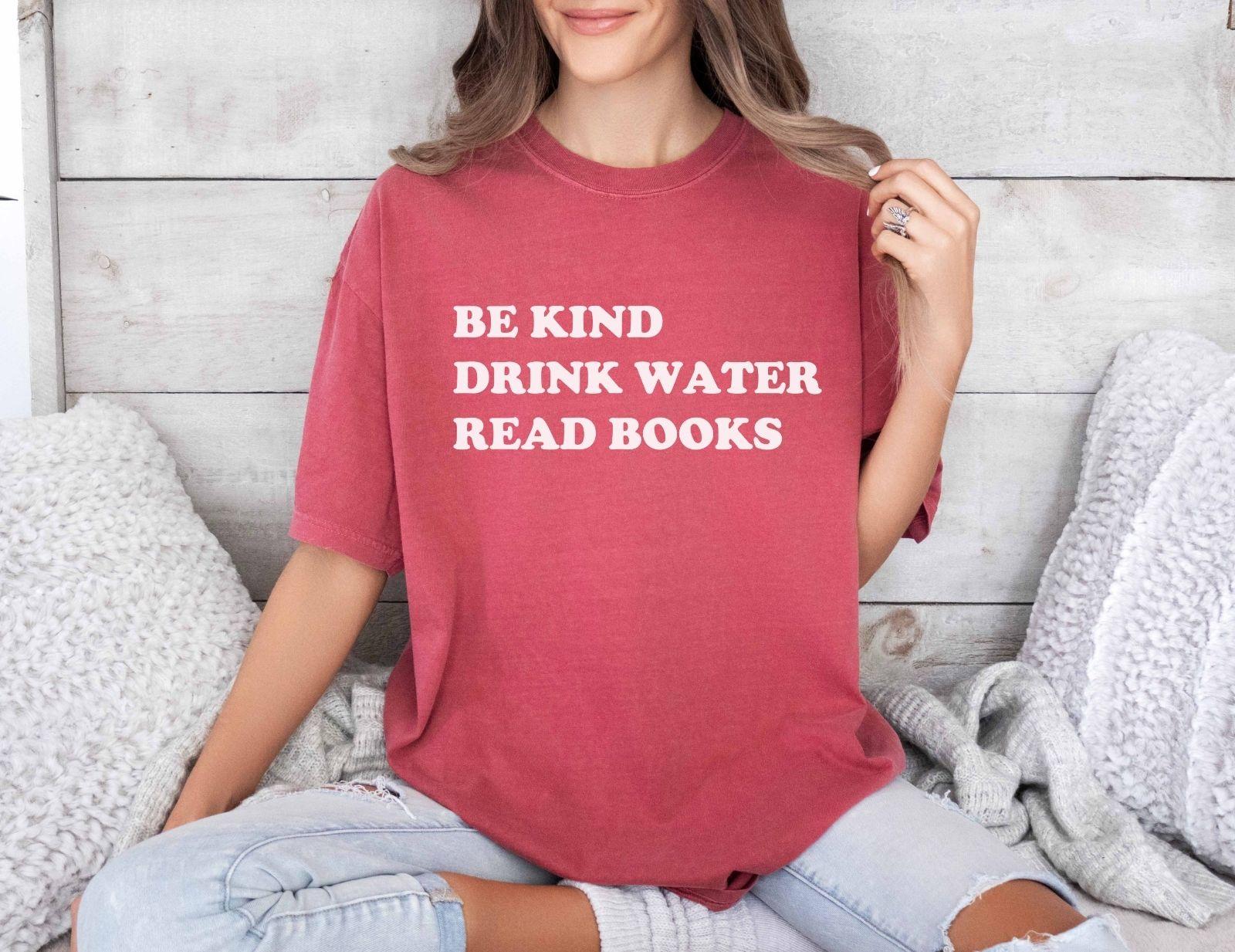 A comfort colors® shirt with the saying "be kind drink water read books"