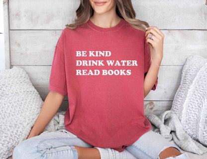 A comfort colors® shirt with the saying "be kind drink water read books"