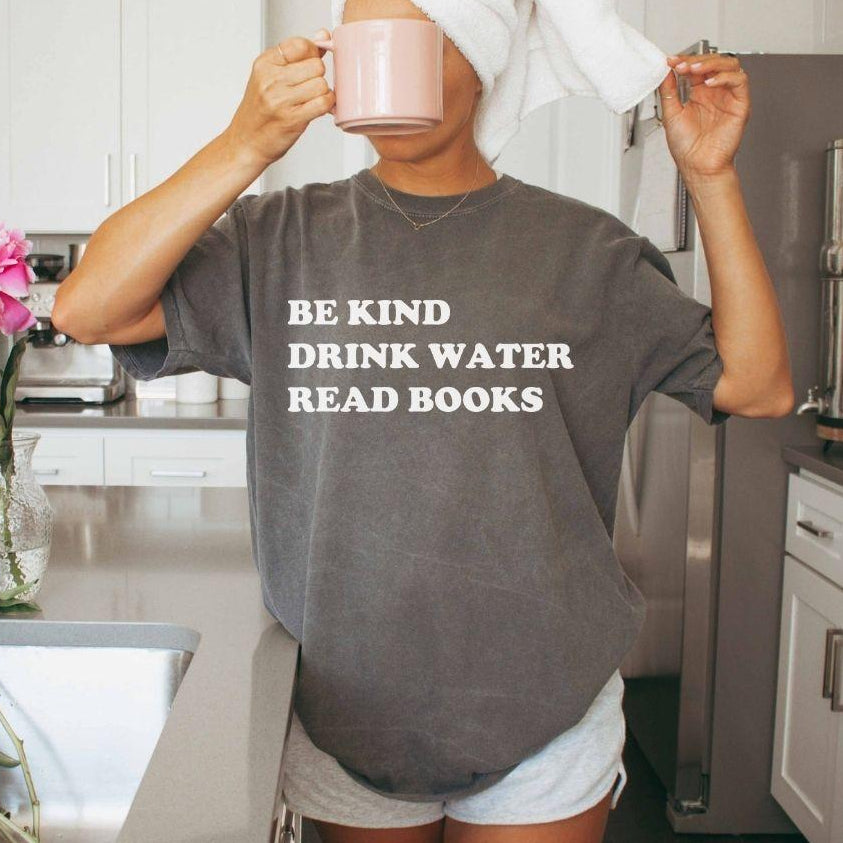 A comfort colors® shirt with the saying "be kind drink water read books"