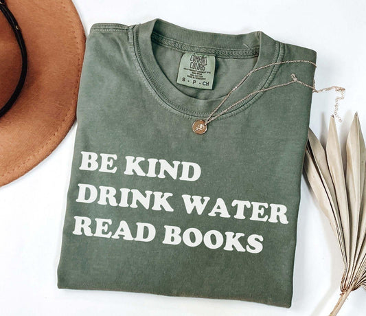 A comfort colors® shirt with the saying "be kind drink water read books"