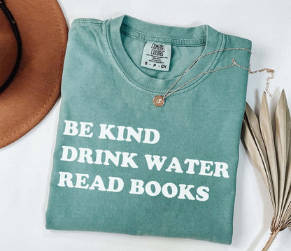 A comfort colors® shirt with the saying "be kind drink water read books"