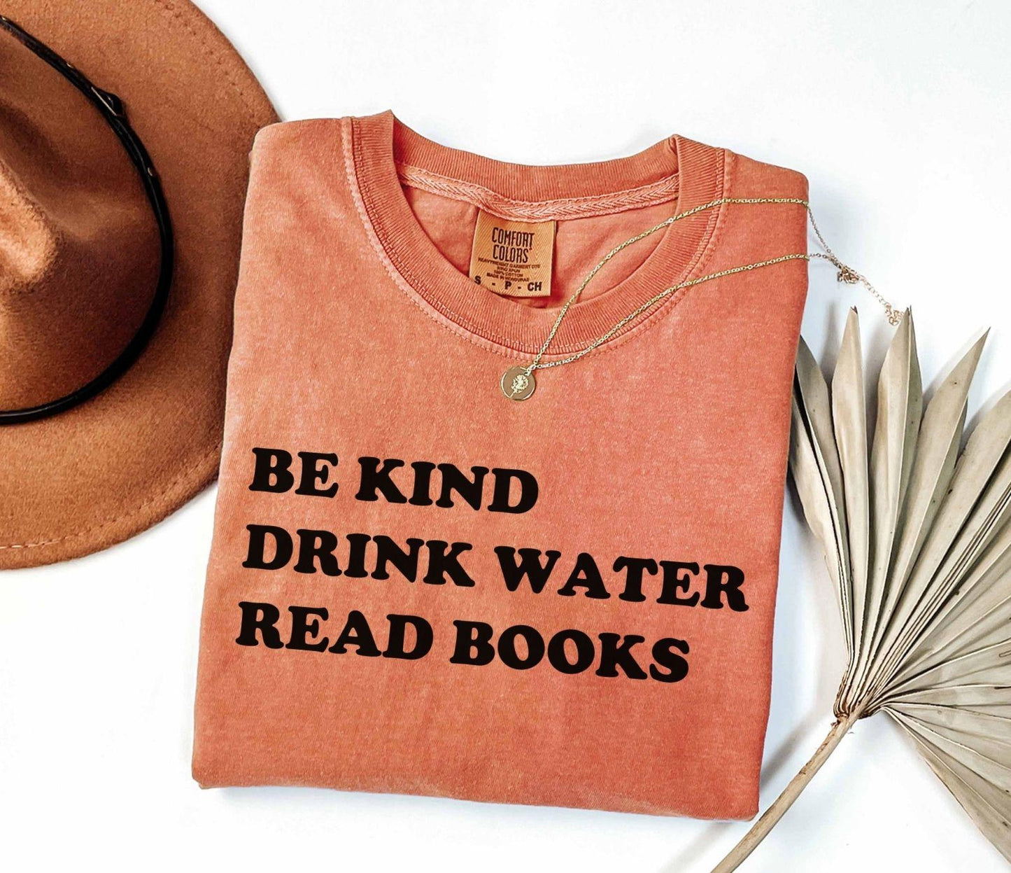 A comfort colors® shirt with the saying "be kind drink water read books"