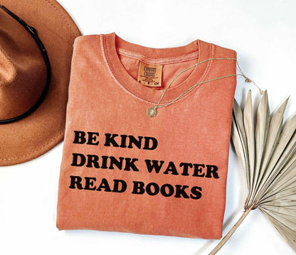 A comfort colors® shirt with the saying "be kind drink water read books"