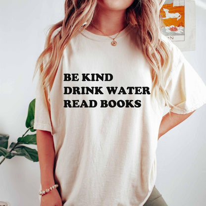 A comfort colors® shirt with the saying "be kind drink water read books"