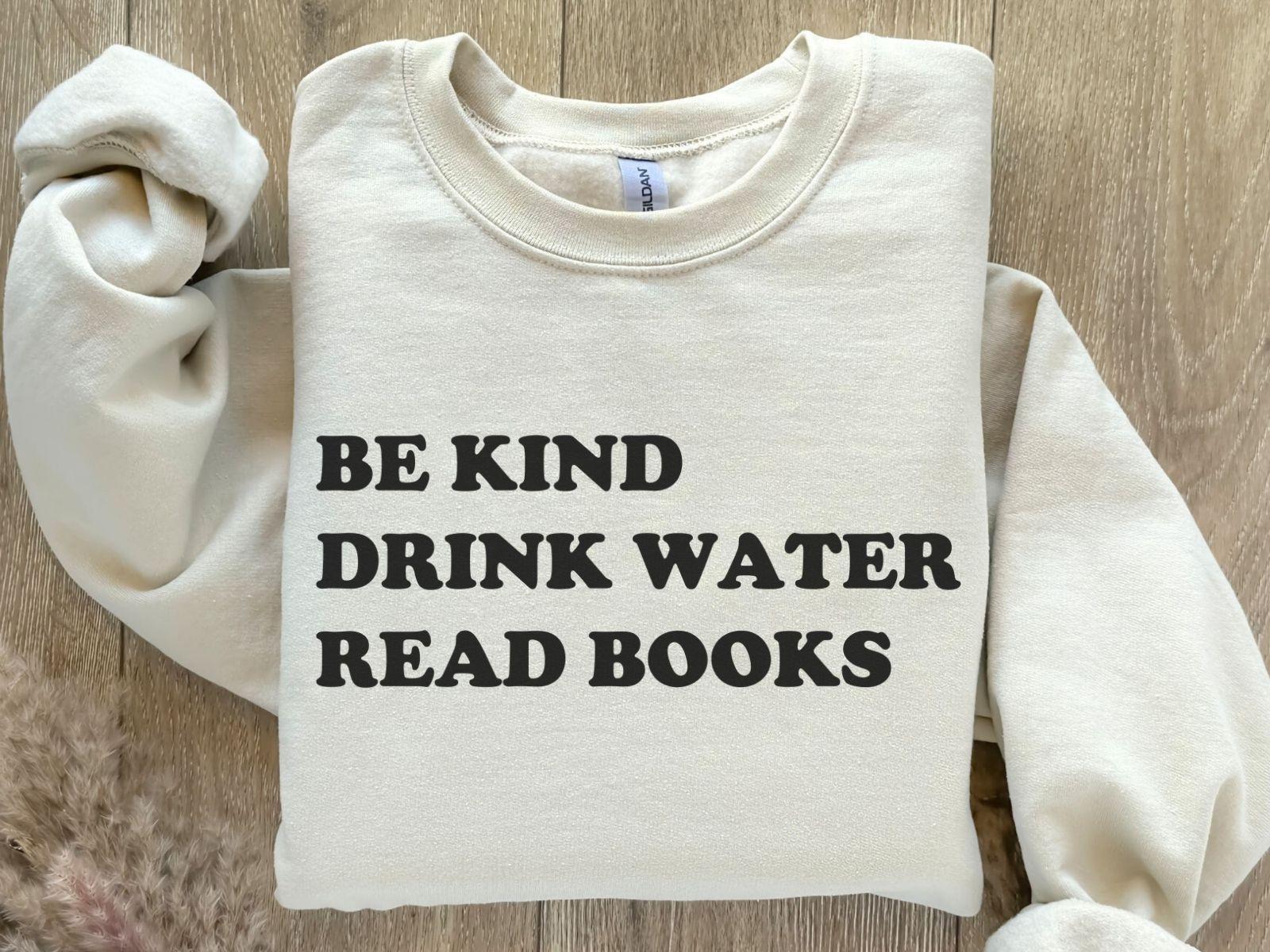 A Gildan 18000 sweatshirt with the saying "be kind drink water read books"