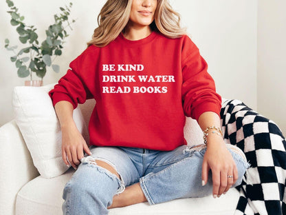 A Gildan 18000 sweatshirt with the saying "be kind drink water read books"