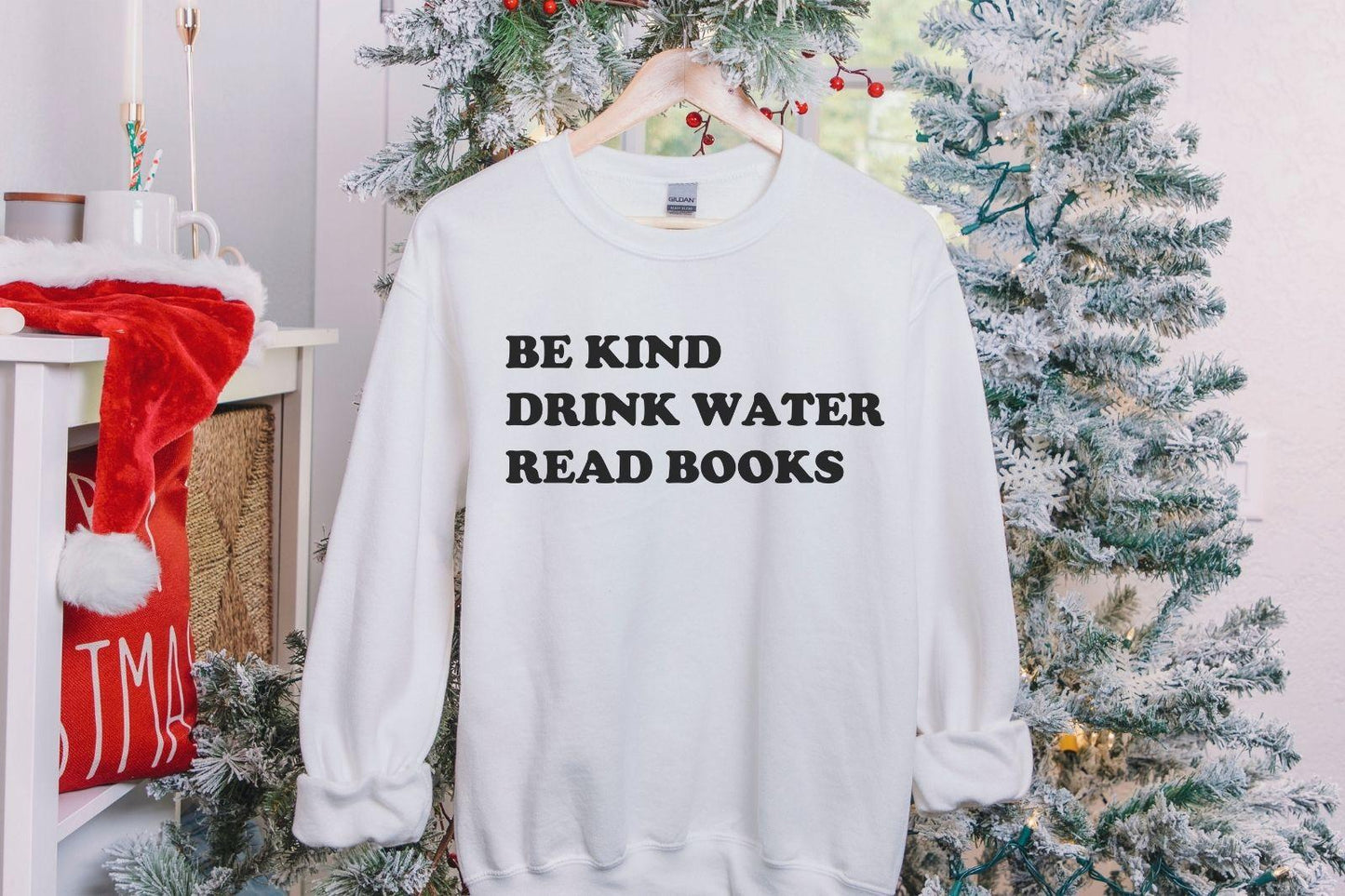 A Gildan 18000 sweatshirt with the saying "be kind drink water read books"