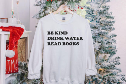 A Gildan 18000 sweatshirt with the saying "be kind drink water read books"