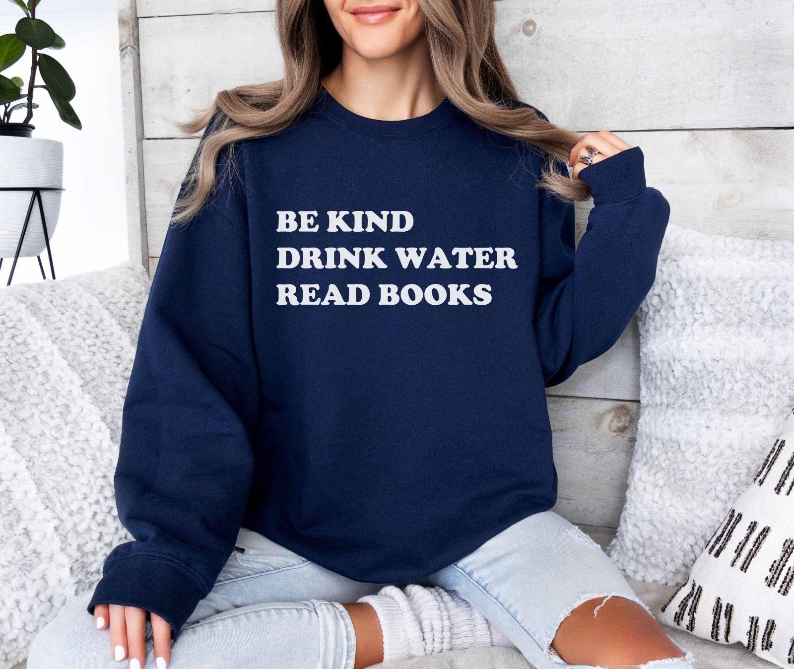 A Gildan 18000 sweatshirt with the saying "be kind drink water read books"