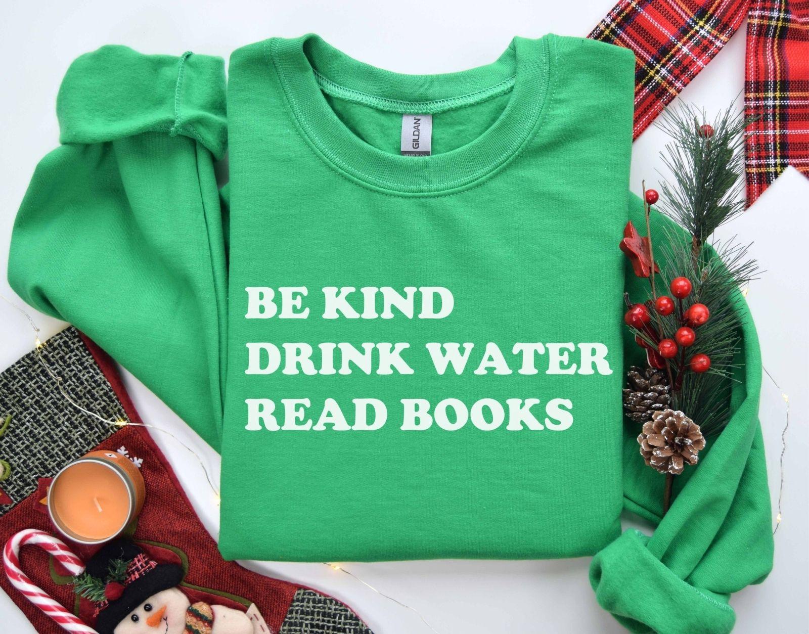 A Gildan 18000 sweatshirt with the saying "be kind drink water read books"