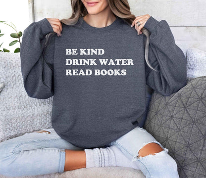 A Gildan 18000 sweatshirt with the saying "be kind drink water read books"