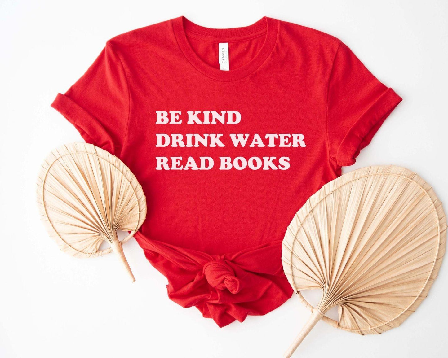 A comfort colors® shirt with the saying "be kind drink water read books"