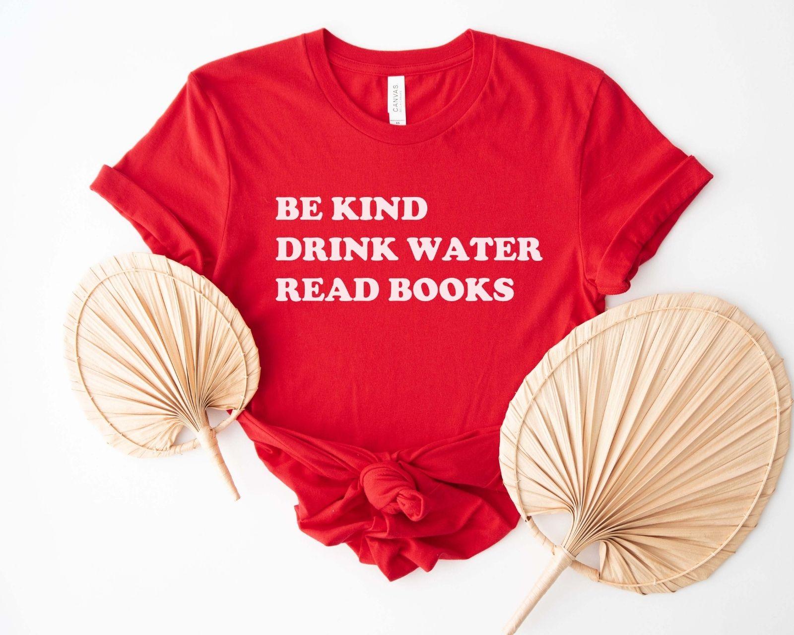 A comfort colors® shirt with the saying "be kind drink water read books"