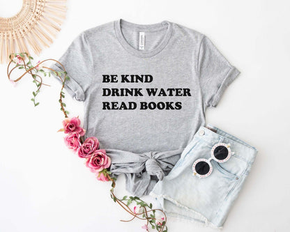 A comfort colors® shirt with the saying "be kind drink water read books"