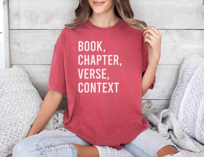 A comfort colors® shirt with the saying "book chapter verse context"